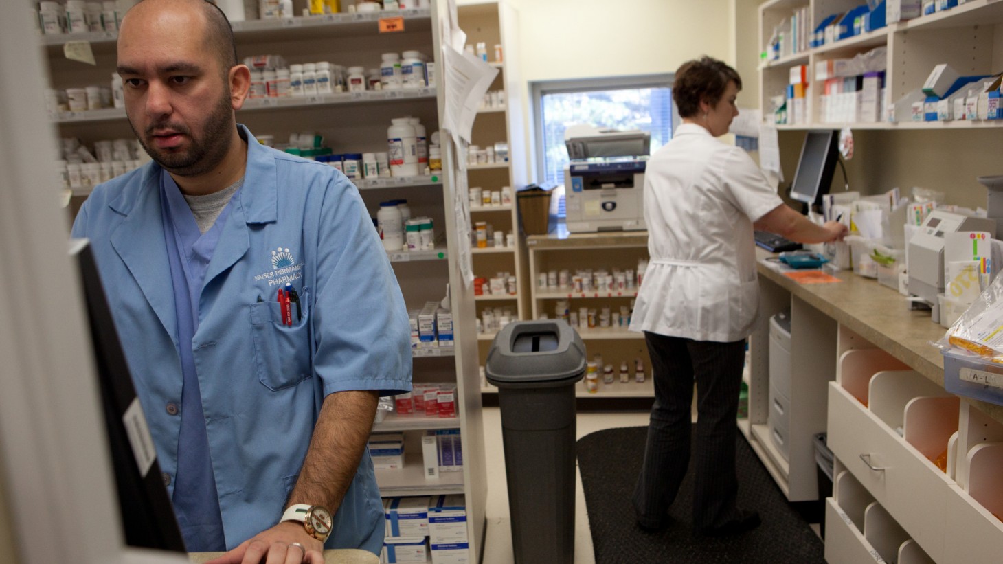 Two workers in a pharmacy
